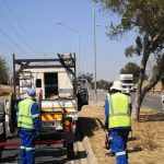 Technicians working roadside beside a utility vehicle